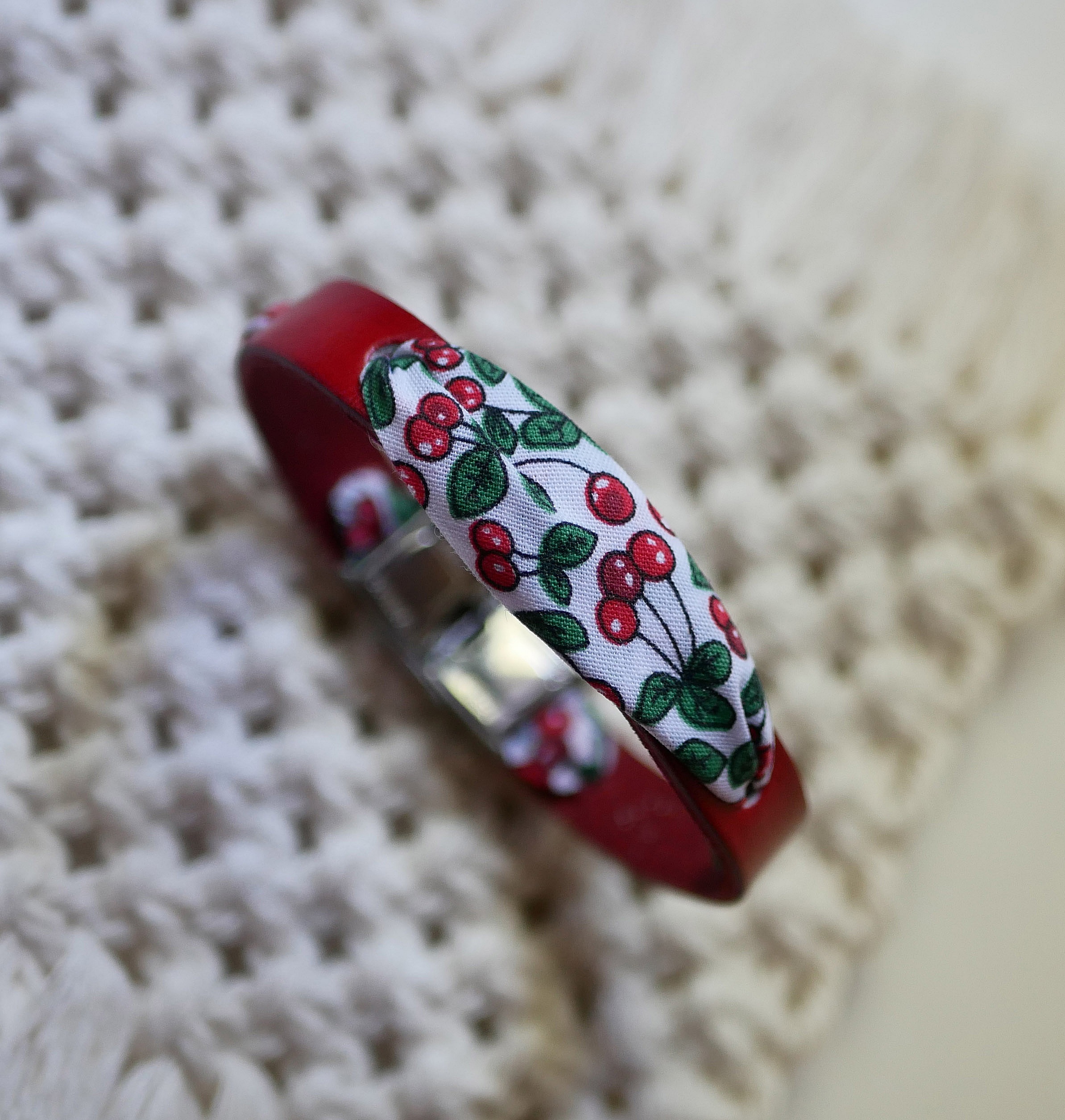 Flor&acirc;me-armb&aring;nd med b&aring;nd af kirseb&aelig;rfrugter p&aring; r&oslash;dt l&aelig;der