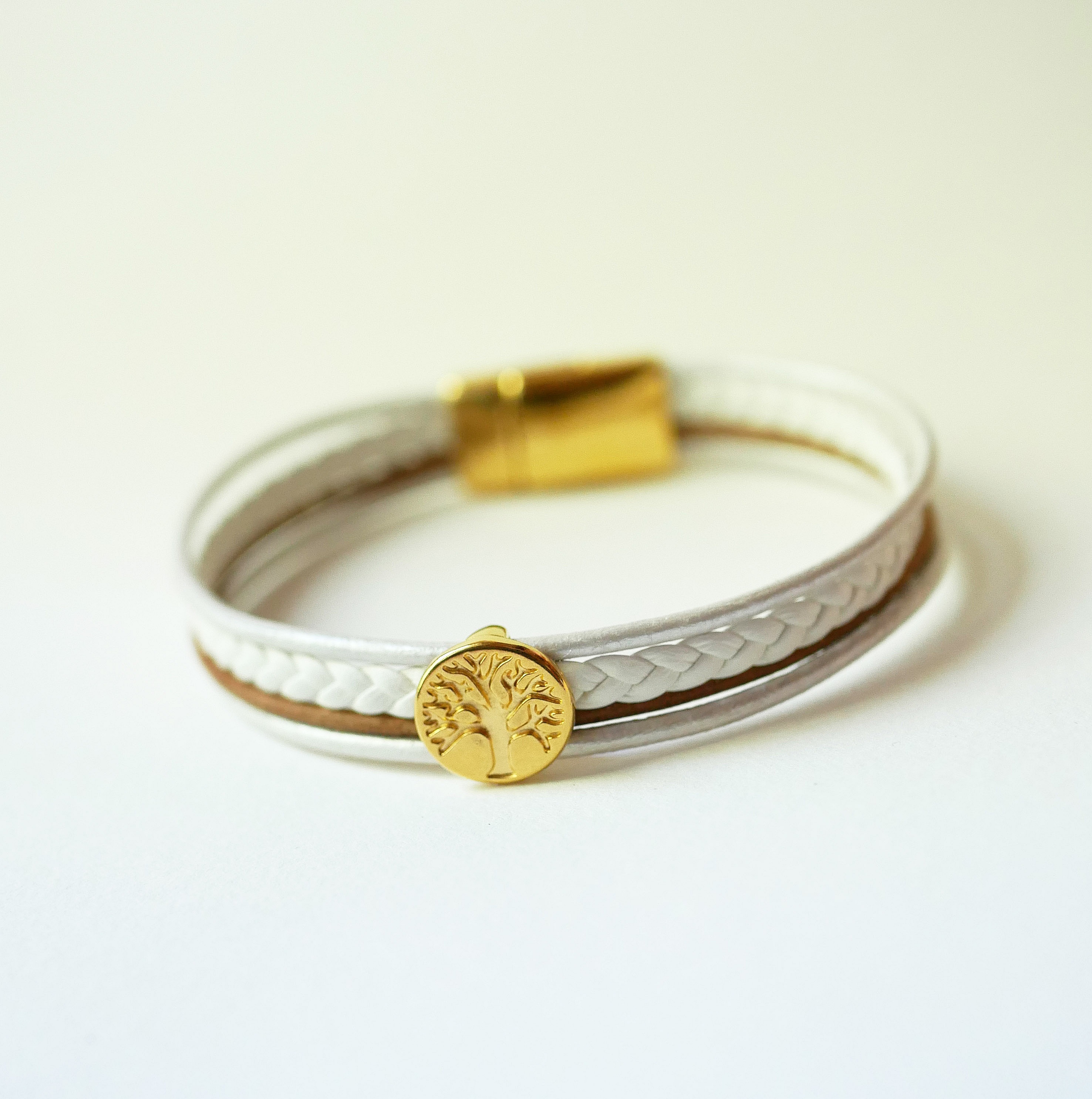 Manchetarmb&aring;nd i hvidt og guld med cabochon af livets tr&aelig;