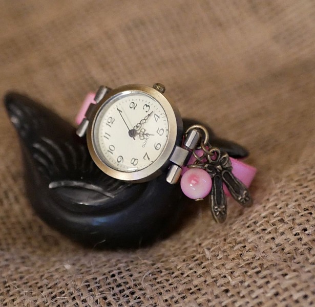 Montre fille bracelet cuir rose avec breloque danse bronze.
